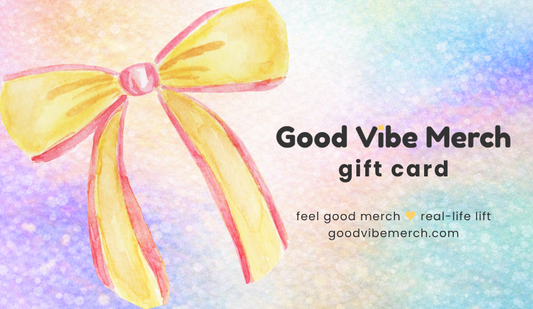 Gift card with a yellow bow on a colorful background, featuring 'Good Vibe Merch' branding.